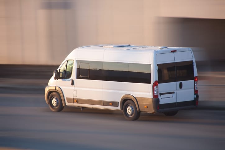 white minibus goes Example of a minibus that would require minibus insurance