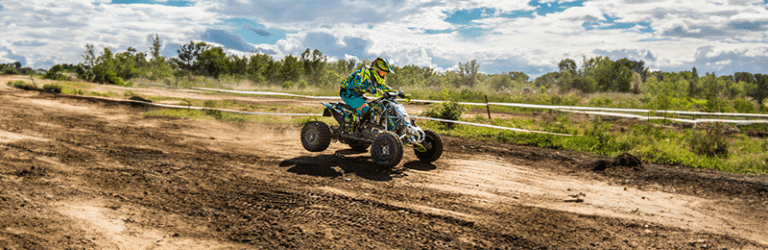 quad bike riding on a dirt road