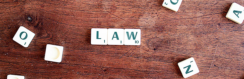 Scrabble tiles spelling 'Law'