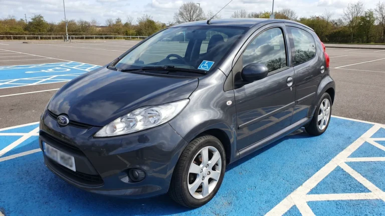 a car parked in an accessible bay with a Blue Badge on the dashboard