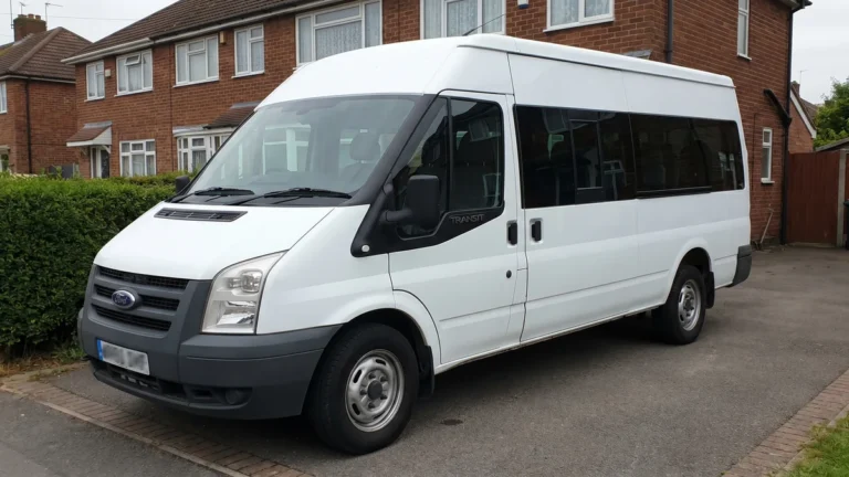 a plain white UK minibus parked on a residential driveway